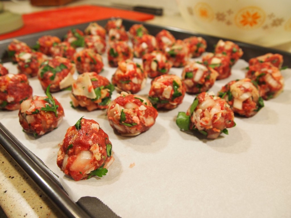 baking sheet almost filled with meatballs